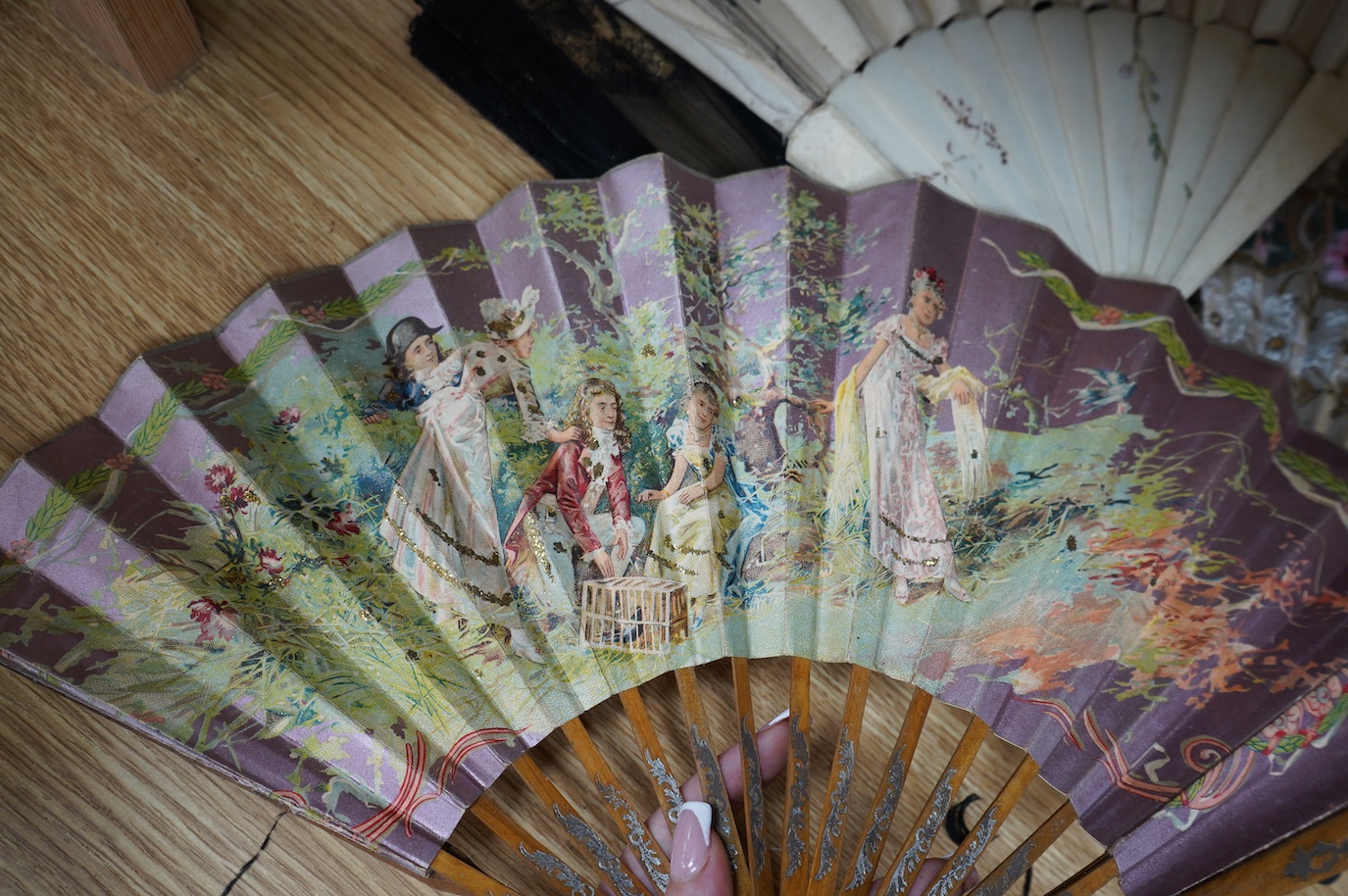 A group of 19th/20th century fans and two parasols, largest fan 33cm, (14). Condition - poor to fair.